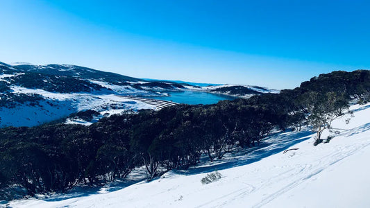 Snowy landscape with a lake, showcasing Australia’s ski resorts.