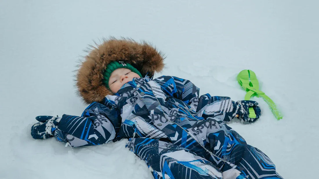 Boy in ski goggles and waterproof boys snow bib