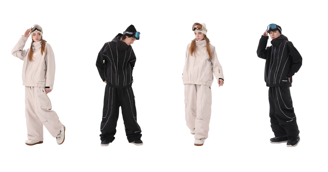 Couple in beige and black ski suits with jackets, pants, and goggles posing together