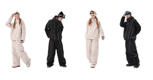 Couple in beige and black ski suits with jackets, pants, and goggles posing together
