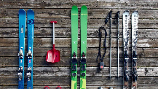 Baggy snowpants and ski gear laid out on wooden floor