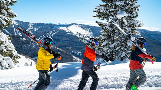 Adults wearing waterproof ski clothes on snowy mountain