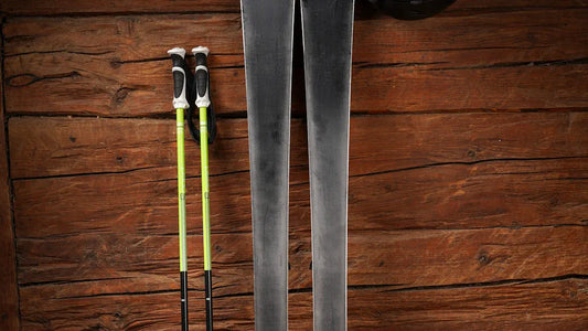 Ski poles and skis laid out for downhill skiing.