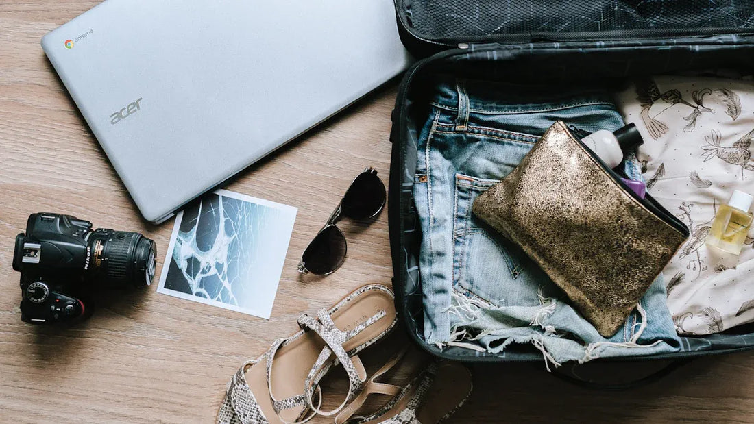 Ski trip packing essentials, laptop, camera, and clothes for the journey.