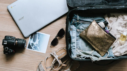 Ski trip packing essentials, laptop, camera, and clothes for the journey.