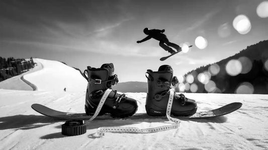Snowboard boots and a snowboard with measuring tape, showing how to size snowboard boots and board.