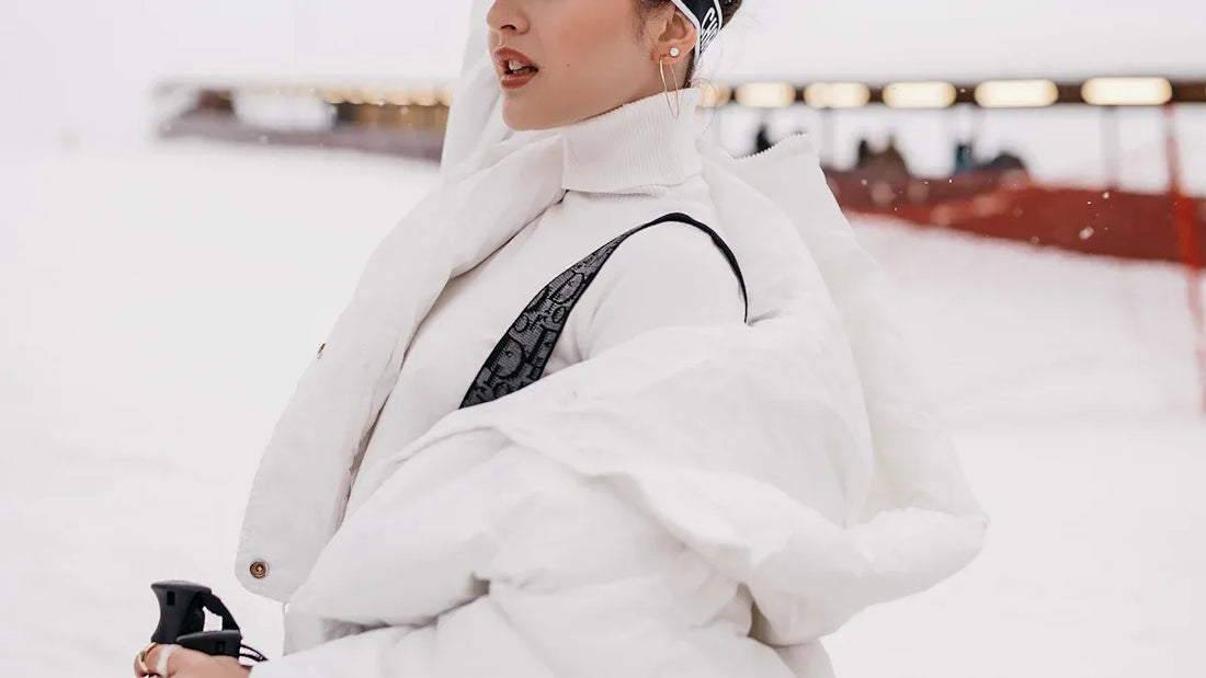 white one‑piece womens snowsuit on snowy slope