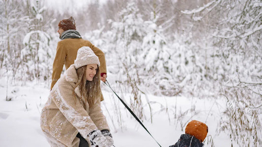 Family enjoying winter activities at a snow-covered ski resort.