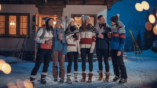 Ski town outfits: group of friends in cozy winter attire at a snowy resort.