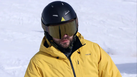 Mens yellow snowboarding jacket with black helmet and goggles.